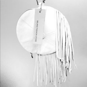 Round white leather handbag with leather fringe.